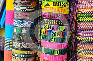 Numerous colorful wristbands with Oaxaca sight for sale at craft