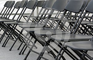numerous folding chairs arranged in a row