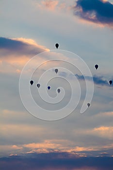 numerous hot air balloons in the evening sky