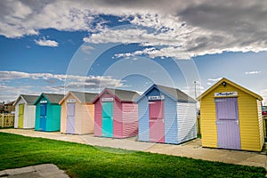 Numerous multi coloured beach huts
