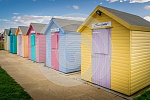 Numerous multi coloured beach huts