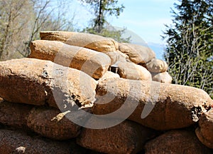 numerous sandbags piled up in the narrow trench during wartime to protect frontline soldiers