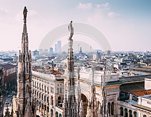 Numerous statues on steeples Duomo di Milano watches on city lif photo