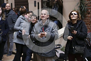 Numerous tourists are photographed in the courtyard of Juliet`s house. People make selfies