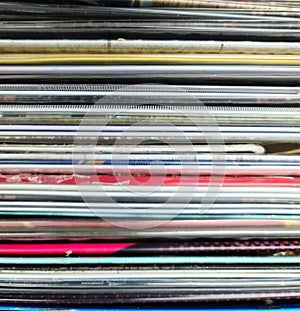 Numerous vintage signs and vinyl records in a box seen from above