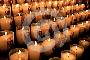 Numerous votive candles