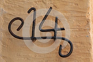 Nummber 14 made from thick wire on wall