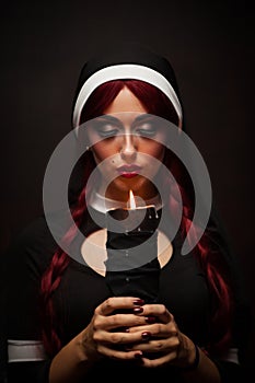 Nun with a candle in hands