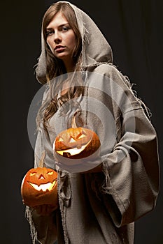 Nun holding halloween pumpkins
