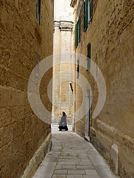 Nun and old walls.