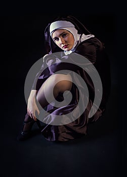 Nun sitting exposing leg