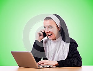 Nun working on laptop - religious concept