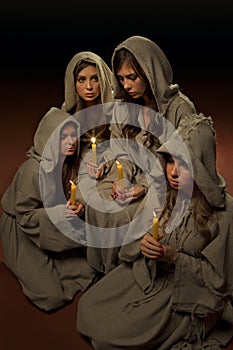 Nuns praing with candles