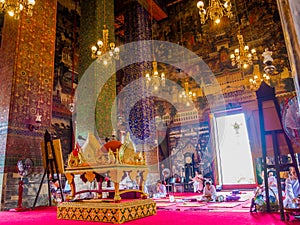 Nuns are preying on large ancient temple with Thai lectern.