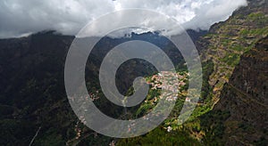 `Nuns Valley` village sites in deep steep sided valley with low clouds Madeira Portugal.