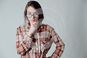 Nurd brunette girl looking strictly and seriously at camera