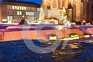 Nuremberg, Germany-Christmas Market in rain- blurred evening scenery photo