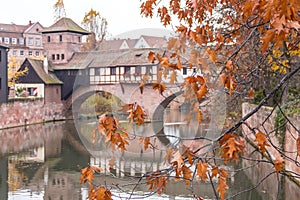 Nuremberg landmark. Medieval houses and bridge over canal with autumn trees. Old town of Nuremberg, Germany.