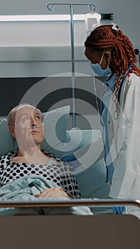Nurse and african american doctor looking at patient results