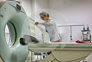 nurse arranging the MRI machine for the next patient