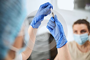 Nurse assembling the syringe needle and a vacuum tube holder