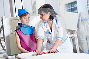 Nurse assistant with little boy preparing or x-ray radiography