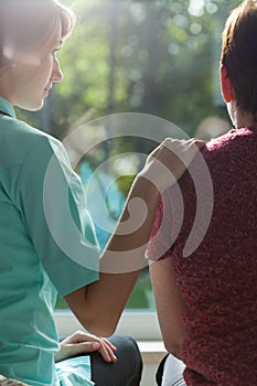 Nurse assisting adult woman