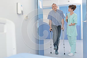 nurse assisting patient with broken leg