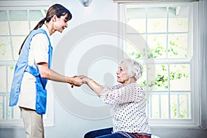 Nurse assisting senior woman