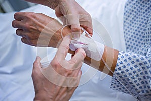 Nurse attaching iv drip on patient s hand