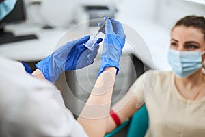 Nurse attaching the needle to the tube holder prior to blood drawing