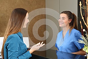 Nurse attending patient in a reception desk photo