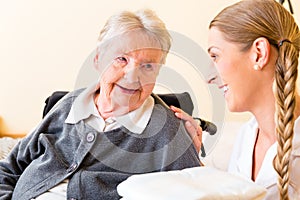 Nurse bringing supplies to woman in retirement home