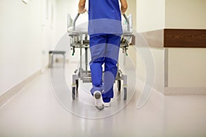 Nurse carrying hospital gurney to emergency room photo