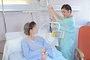 Nurse changing patient`s drip