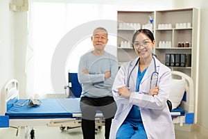 A nurse in charge takes care of a senior man to sleep in a room at the hospital department. Asian female doctor talking