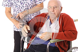 Nurse checking elderly patients blood pressure photo