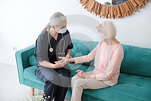 Nurse checking old lady at home appointment