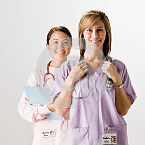 Nurse co-workers wearing scrubs and stethoscopes