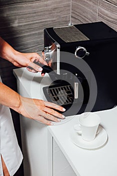 Nurse in cosmetic beauty parlour making coffee