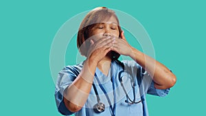 Nurse covering mouth with hands