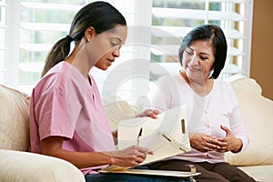 Nurse Discussing Records With Senior Female Patient photo