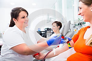 Nurse disinfecting puncture point before blood donation