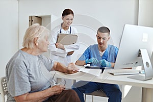 a nurse and a doctor examining a patient hospital professional consultation