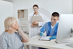 a nurse and a doctor examining a patient hospital professional consultation