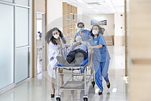 Nurse and doctor in a hurry taking patient to operation theatre. Doctors running for the surgery. Team of doctors and surgeon