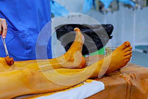 nurse and doctor prepare patient for surgery patient readiness in surgery room antiseptic solution on skin