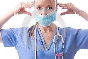 Nurse or doctor putting on PPE a medical face mask