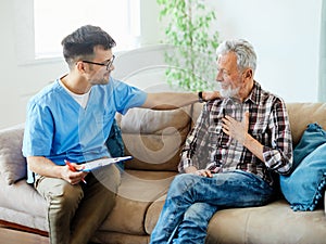 nurse doctor senior care caregiver help assistence retirement home nursing elderly man insurance sofa document writing