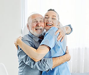 nurse doctor senior care hug hugging bonding embracing friend patient health help assistence retirement home elderly man